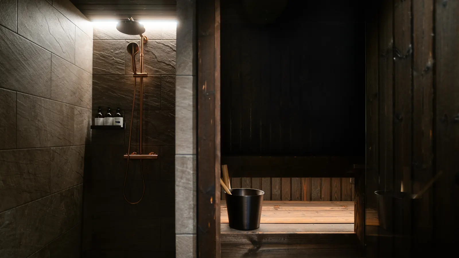 The private wood-panelled sauna and rain shower inside a Hillside igloo
